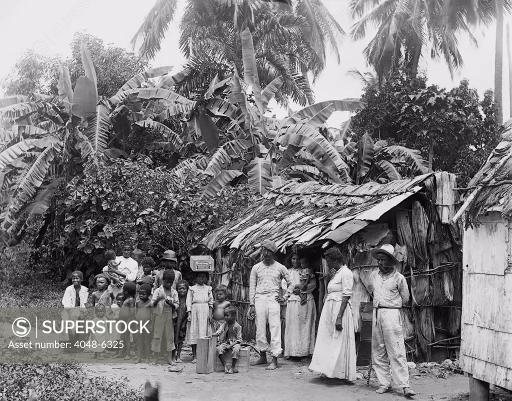 Puerto Ricans in front of a primitive dwelling shortly after Puerto Rico was annexed by the United States after the Spanish American war. Ca. 1903.