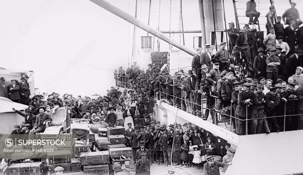 A crowd of European immigrants and their luggage on the THE IMPERATOR, then the world's largest Ocean Liner,  arriving in New York Harbor on June 19, 1913 with over 4,000 passengers.  The liner of the Hamburg-American Line carried 1800 third class and steerage passengers, and over 850 in first class. June 1913.