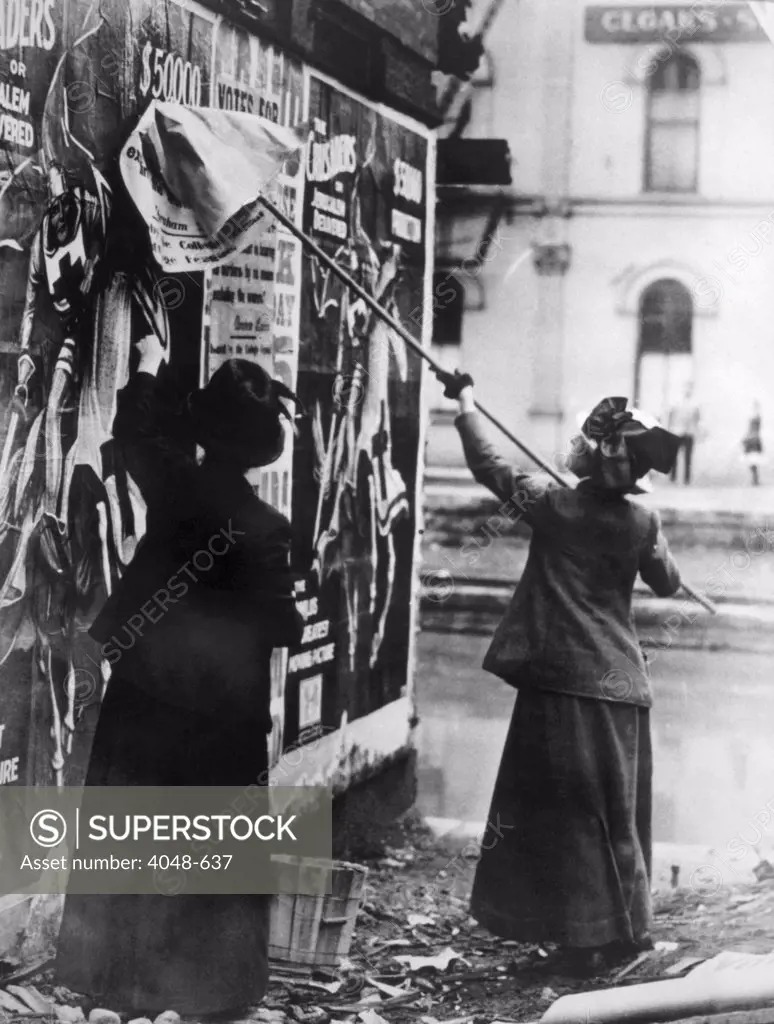 Two suffragettes posting a billboard in New York City, c. 1917.
