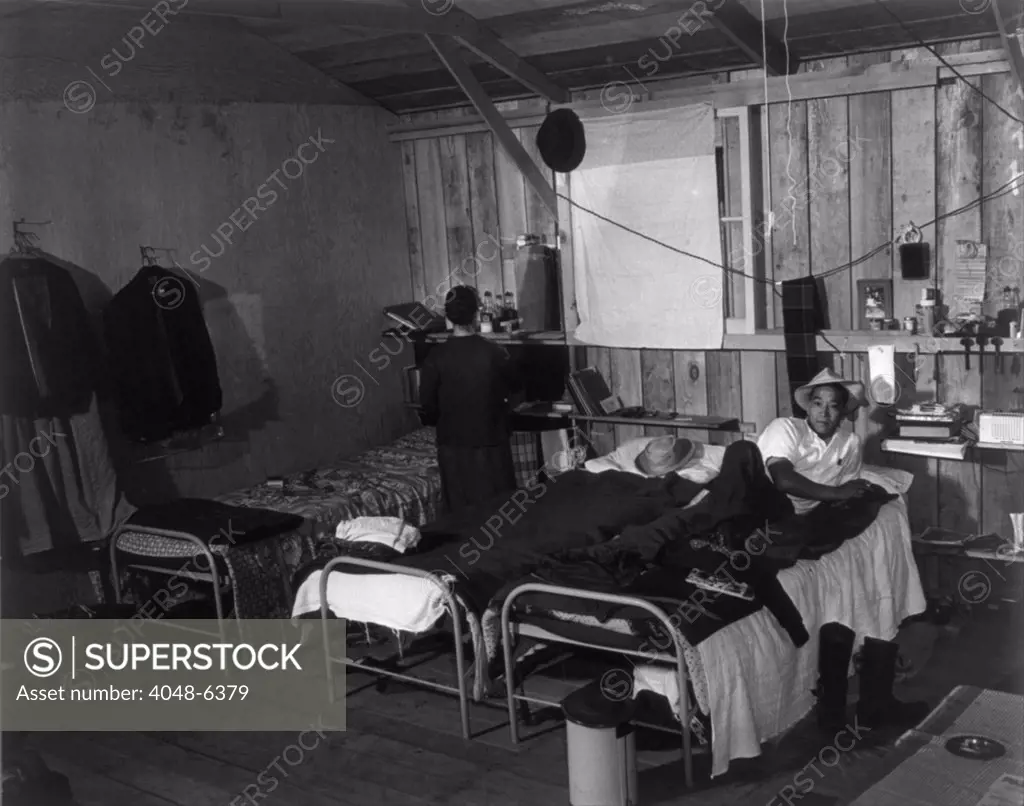 Japanese-American couple in bleak barracks quarters at the Salinas, California assembly center in March 1942. From this initial detention facility the would be transferred to one of ten internment camps for the duration of World War II. March 1942.