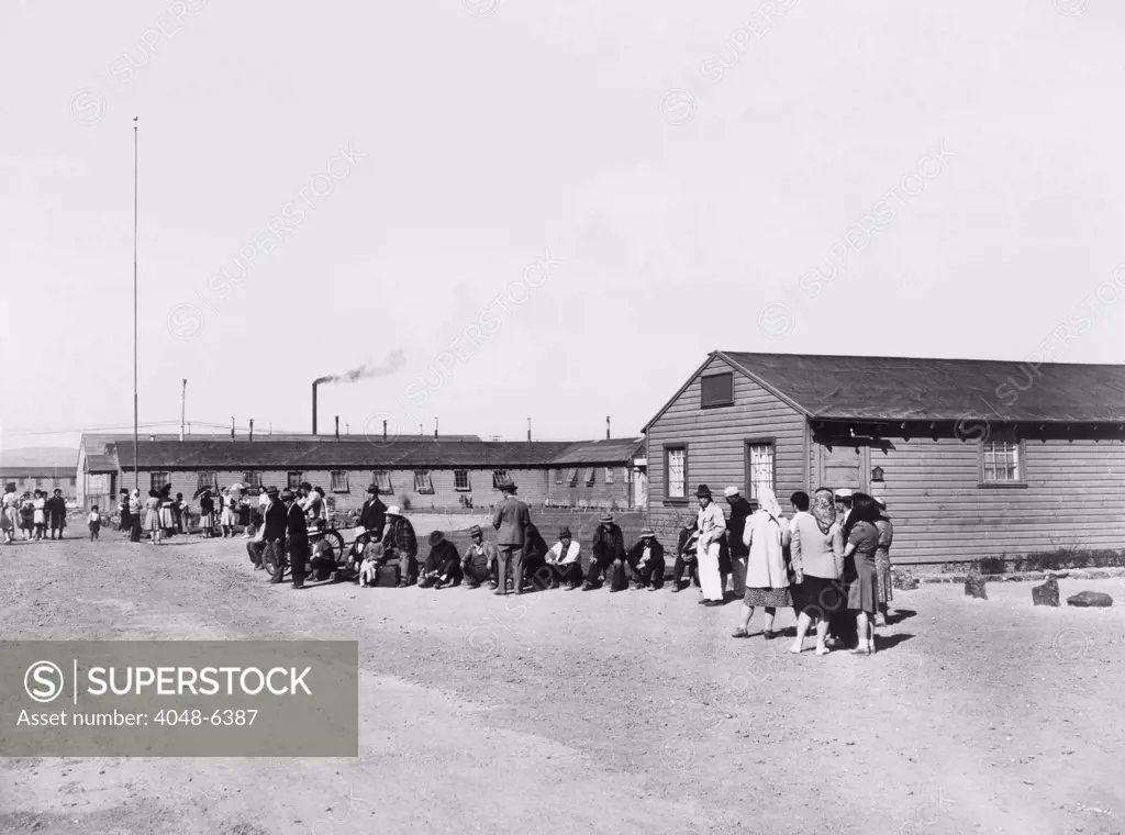 Japanese Americans amid the tar paper barracks of the Tule Lake Relocation Center in Newell, California. This bleak camp was the scene of Japanese American resistance to incarceration during World War II. Over 5,000 Tule Lake inmates legally renounced their U.S. citizenship in 1944, and over 1000 were repatriated to Japan at the end of World War II.