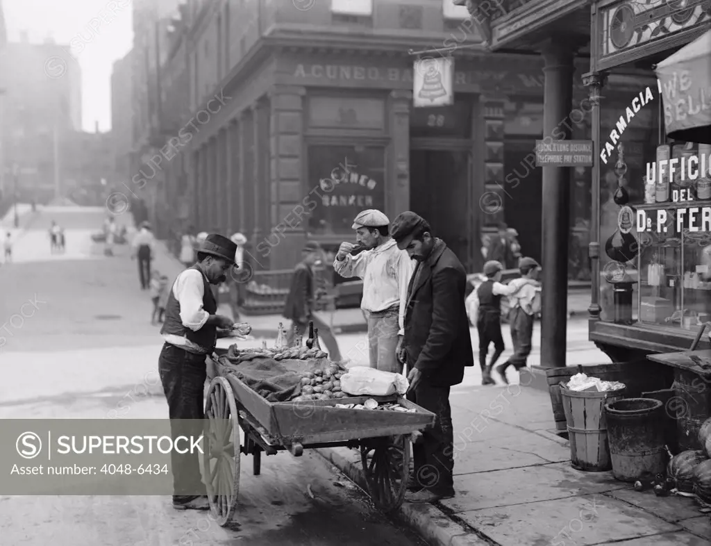 Men eating fresh clams from a pushcart peddler in the Italian neighborhood of Mulberry Bend in New York City. Ca. 1900 photograph by Byron.