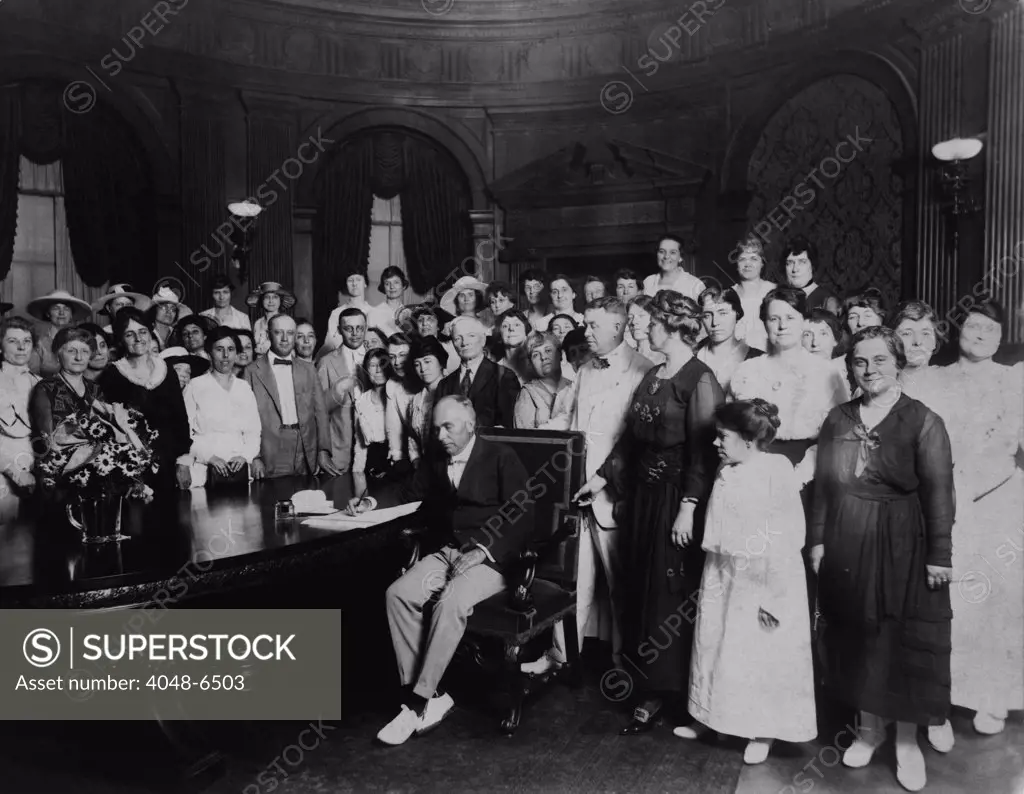 A room full women and a few men witness Governor Frederick Gardner signing Missouri's ratification of the 19th Amendment. Missouri was the 11th state of the required 36 to ratify. January 6, 1920.
