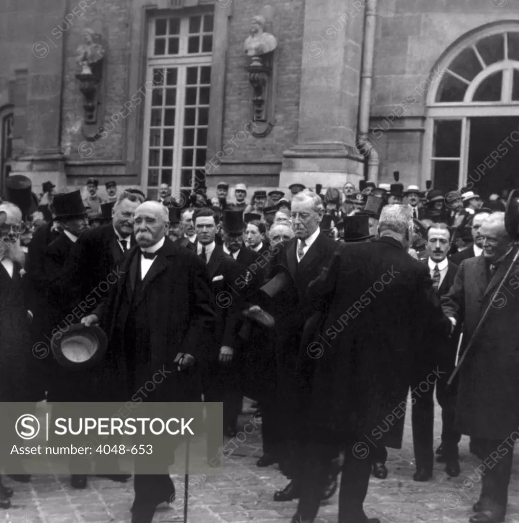 Premier Georges Clemenceau, President Woodrow Wilson, Prime Minister Lloyd George leaving the Palace of Versailles after signing the treaty ending World War I, June 28, 1919
