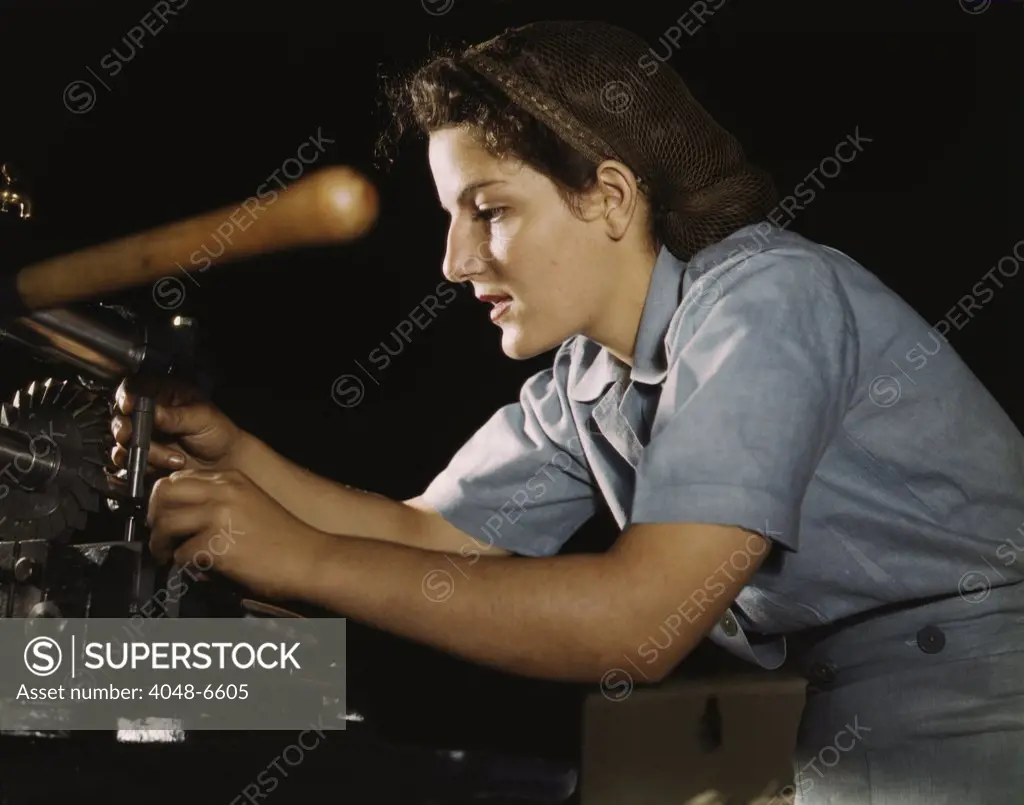 Women war worker finishing airplane parts in a hand mill at Consolidated Aircraft Corporation in Fort Worth, Texas. October 1942.