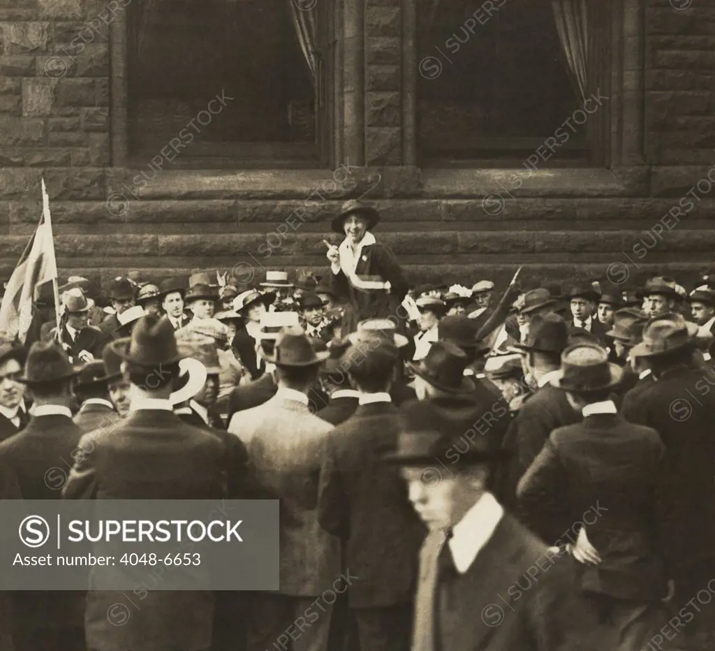Suffragist Mabel Vernon speaking to large crowd of men an Open-Air Meeting in Chicago. In addition to her gifts as a speaker for the National Women's Party, she organized demonstrations and was herself arrested and imprisoned in 1917.