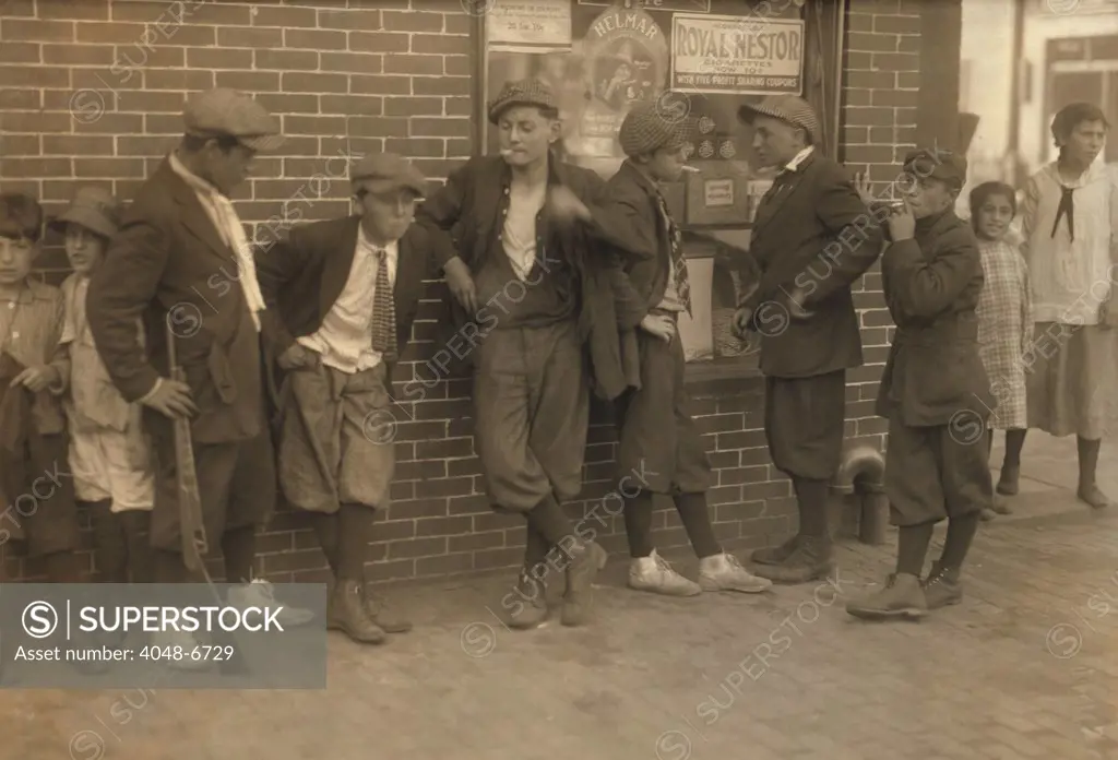 Street gang of cigarette smoking youths loiter on the corner of Margaret & Water Streets in Springfield, Massachusetts. 1916 photo by Lewis Hine.