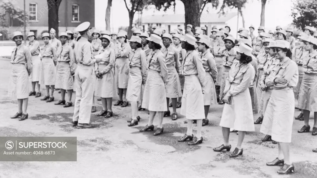 World War II. Women's Army Auxiliary Corps was established in 1941, prior to U.S. entry into World War 2. The Third Platoon, Company 1, Fort Des Moines, Iowa, of African American women stands at ease with their commander, Captain Frank Stillman.