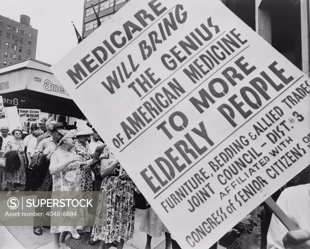 Retired senior citizens carrying pro-Medicare signs, picket outside the Hotel Americana during the American Medical Association's 114th annual convention in 1965. The AMA opposed Medicare, saying it would lead to socialized Medicine and encouraged their members to reject participation in the program.