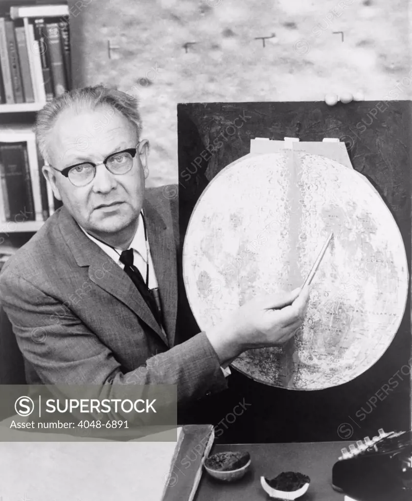 Gerard P. Kuiper (1905-1973), Dutch born American astronomer, holding pointer to a map of the moon. He helped identify landing sites on the moon for the Apollo landing in July 1969 and later missions.