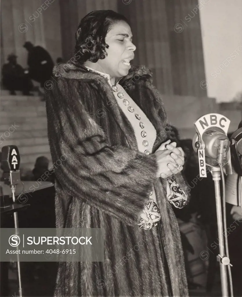 Marian Anderson (1897-1993), at a NBC microphone during her historic concert on the steps of the Lincoln Memorial, singing to a crowd of 75,000 on Easter Day, April 9, 1939. The concert was a landmark event in the African American civil rights struggle.