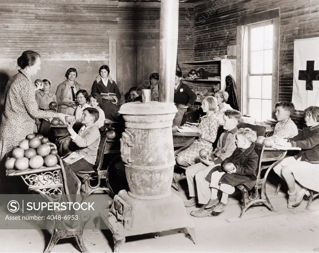 Students in a one-room school near Sunflower, Mississippi receive grapefruit from Red Cross disaster relief during the 1930-31 drought that devastated the regions agriculture. Photo by Lewis Hine.