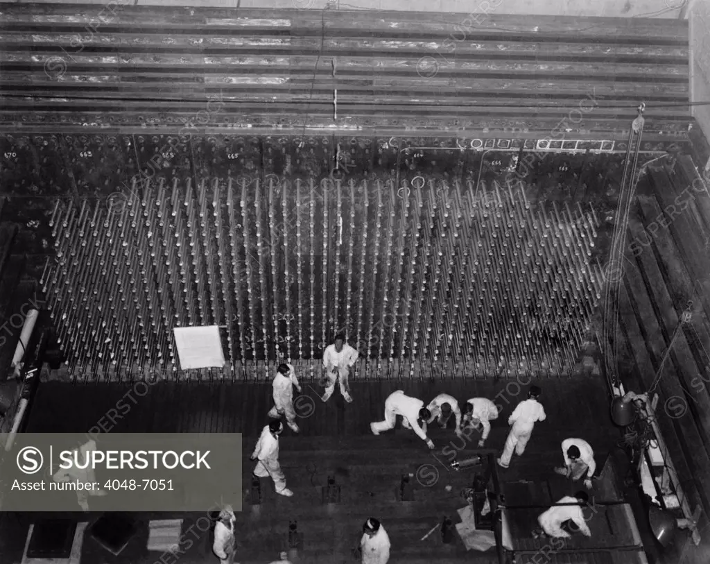 Workers laying up the graphite core of the Reactor-B atomic pile. The pile was 36 feet high, measuring 28 by 36 feet. It was penetrated horizontally by 2,004 fuel tubes and vertically by channels for the vertical safety rods.