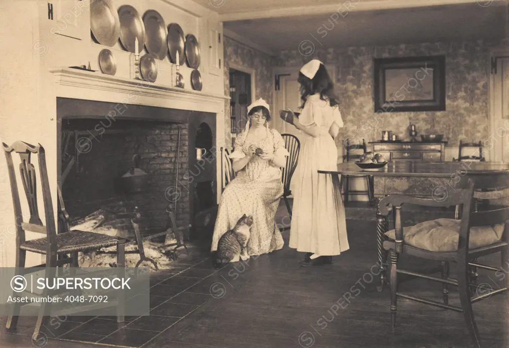 Recreation of a gentile colonial American house with two women in colonial costume. 1913 photo by Wallace Nutting.