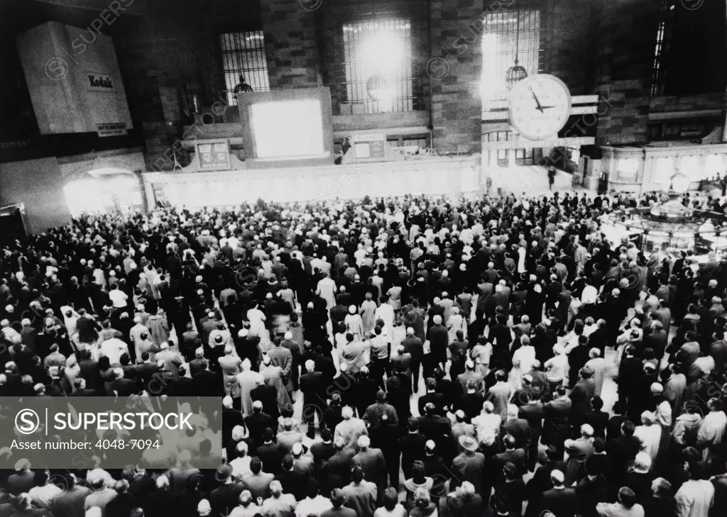 Hundreds of people gathered before a large screen television in New York's Grand Central Station to watch coverage of President Kennedy's funeral on November 25, 1963.
