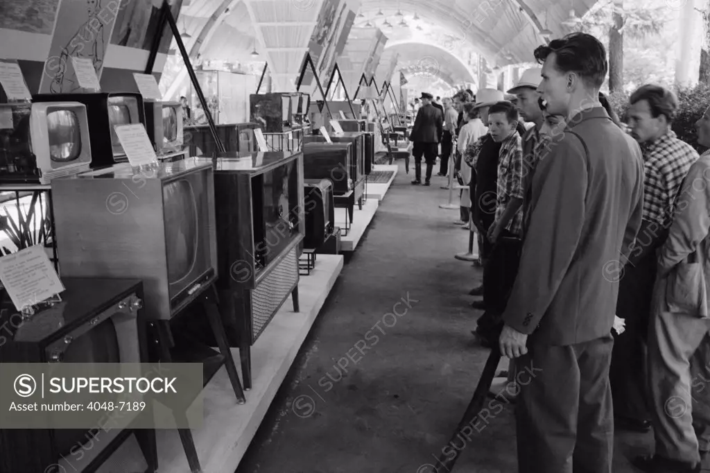 Russians looking at television sets at the American National Exhibition at Sokolniki Park in Moscow on August 5, 1959. A few day earlier the exhibition had been the site of the famous Nixon-Khrushchev kitchen debate.