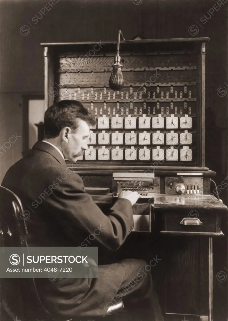 Man working with punch cards in an early tabulating machine at the U.S. Census Bureau, ca. 1908.