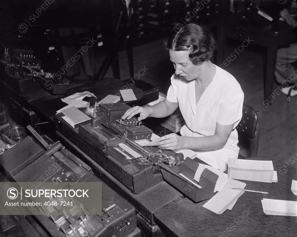 Social Security Administration clerk punching tabulator operation cards, with each hole representing a letter or a numbers. The cards will be fed into the mechanical tabulator, where sensitive steel fingers read the punches, and electrical impulses will create a printed sheet of statistic information. Ca. 1938.