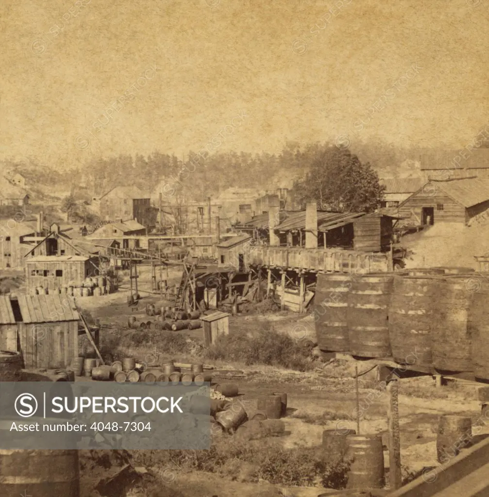 Barrels and buildings at an oil refinery in Erie, Pennsylvania in the 1870s.