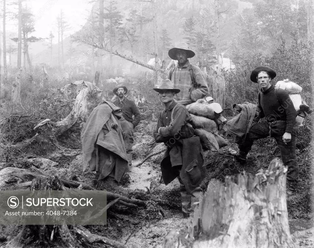 Four prospectors posed on trail in Alaska during the Yukon gold rush in 1897.