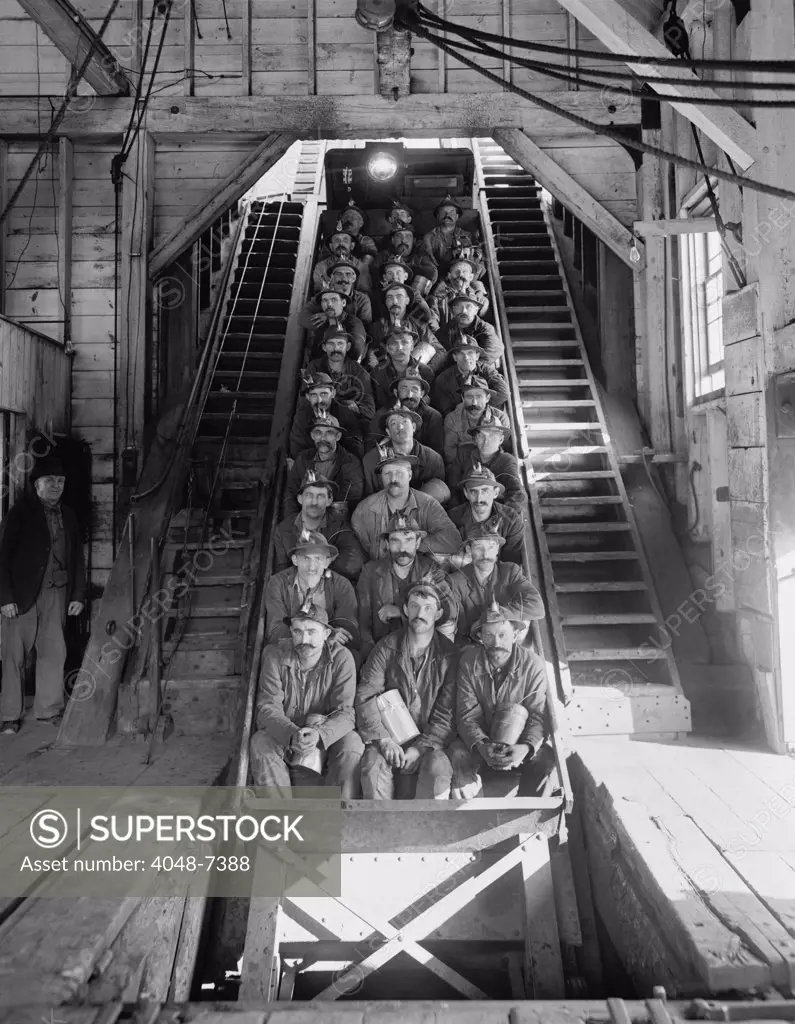 Miners in an open tram at the Calumet and Hecla Mining Company, one of the largest and most profitable copper mines in American in the late 19th and early 20th century, employing 5000 people. The mining superintendents were traditionally Cornishmen; the workers were Finns, Poles, Italians, Irish, and other immigrant nationalities. 1906.