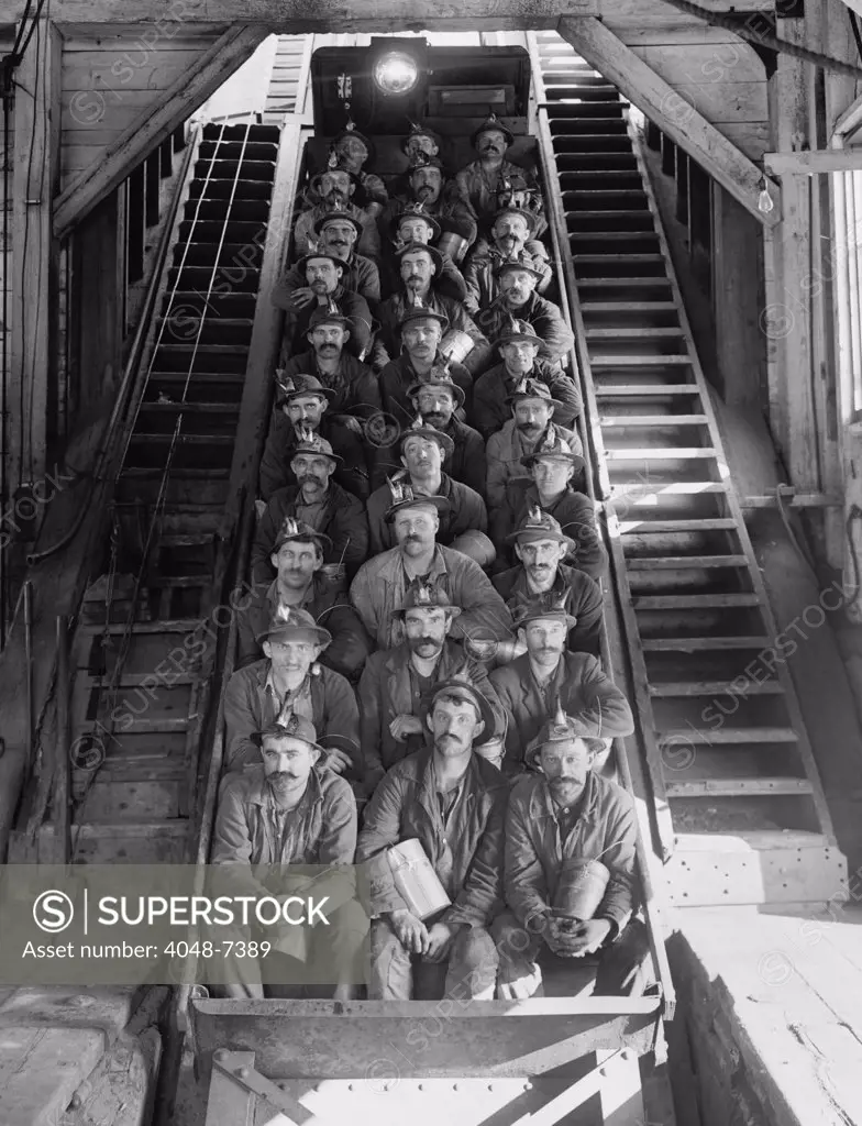 Miners in an open tram at the Calumet and Hecla Mining Company, one of the largest and most profitable copper mines in American in the late 19th and early 20th century, employing 5000 people. The mining superintendents were traditionally Cornishmen; the workers were Finns, Poles, Italians, Irish, and other immigrant nationalities. 1906.