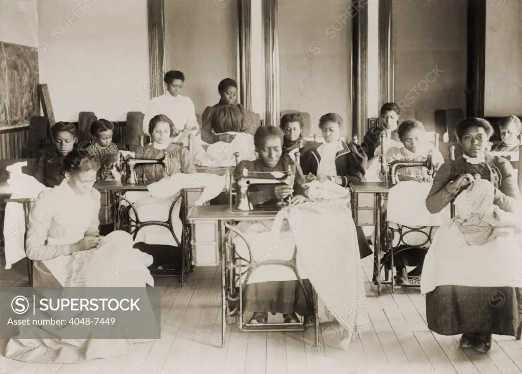 Young African American women sewing with machines and by hand in the sewing class at the Agricultural and Mechanical College, Greensboro, N.C.