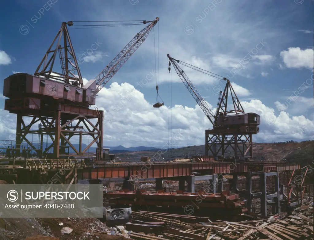 Massive cranes on a steel superstructure during the construction of Douglas Dam, a Tennessee Valley Authority public works project. June 1942.
