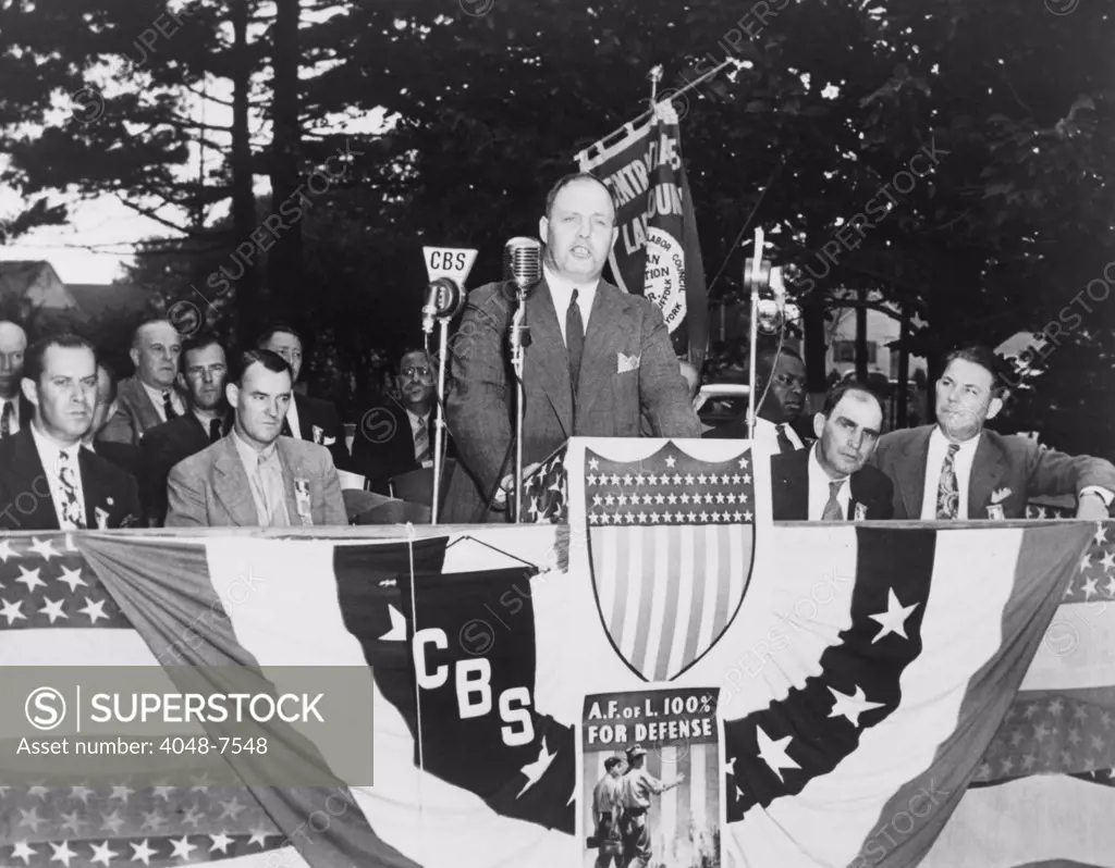 George Meany (1894-1980) speaking into microphones at the Labor Day exercises held by the Nassau-Suffolk AFL (American Federation of Labor) organization, Uniondale, New York in 1941.