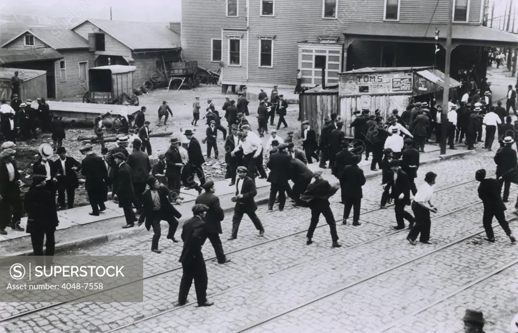 Polish oil refinery workers in Bayonne, New Jersey, confront company guards outside the Standard Oil Works moments before the private police opened fire. Five strikers were killed. July 22, 1915.
