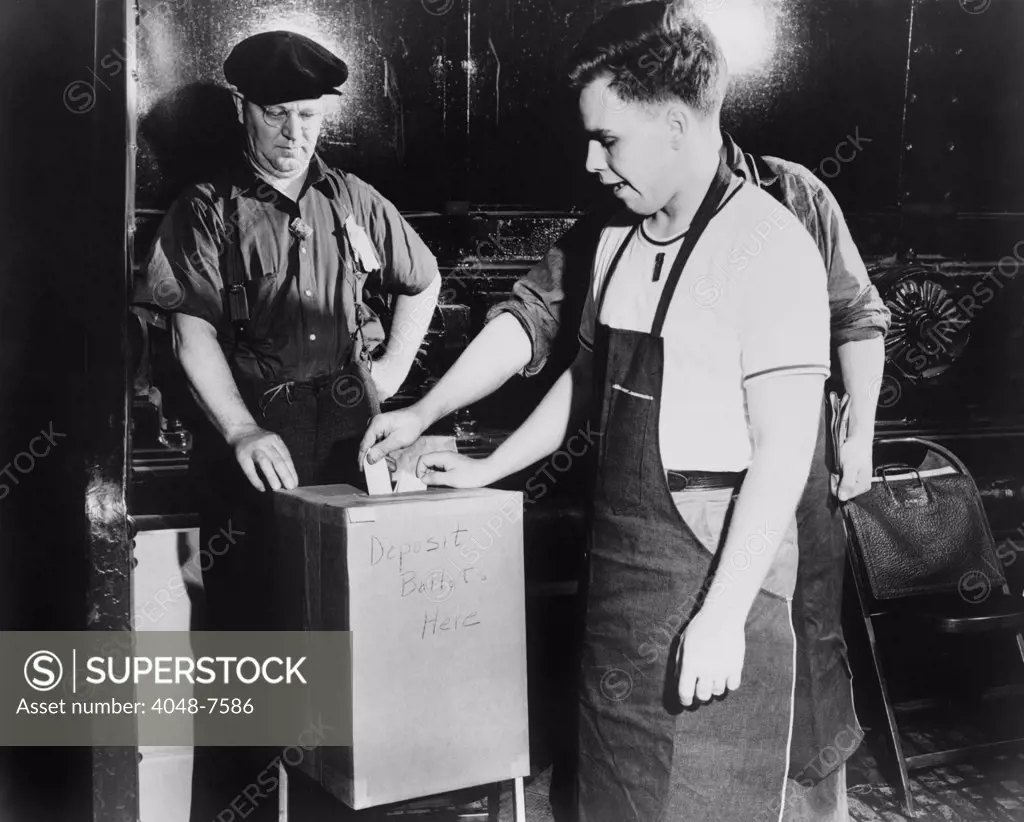 Workers depositing ballot during a National Labor Relations Board election for union representation at the River Rouge Ford plant in Dearborn, Michigan. June 1941.