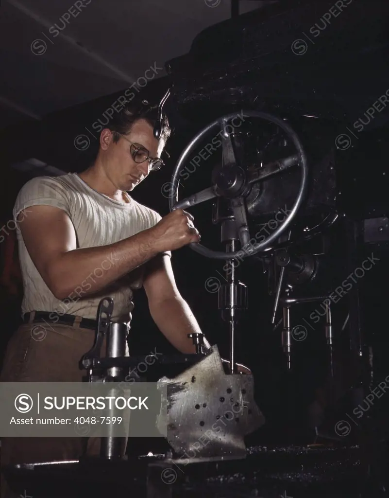 Man operates a drill-press in the North American Aviation's Inglewood, California plant, which built B-25 bombers and Mustang fighters. October 1942,