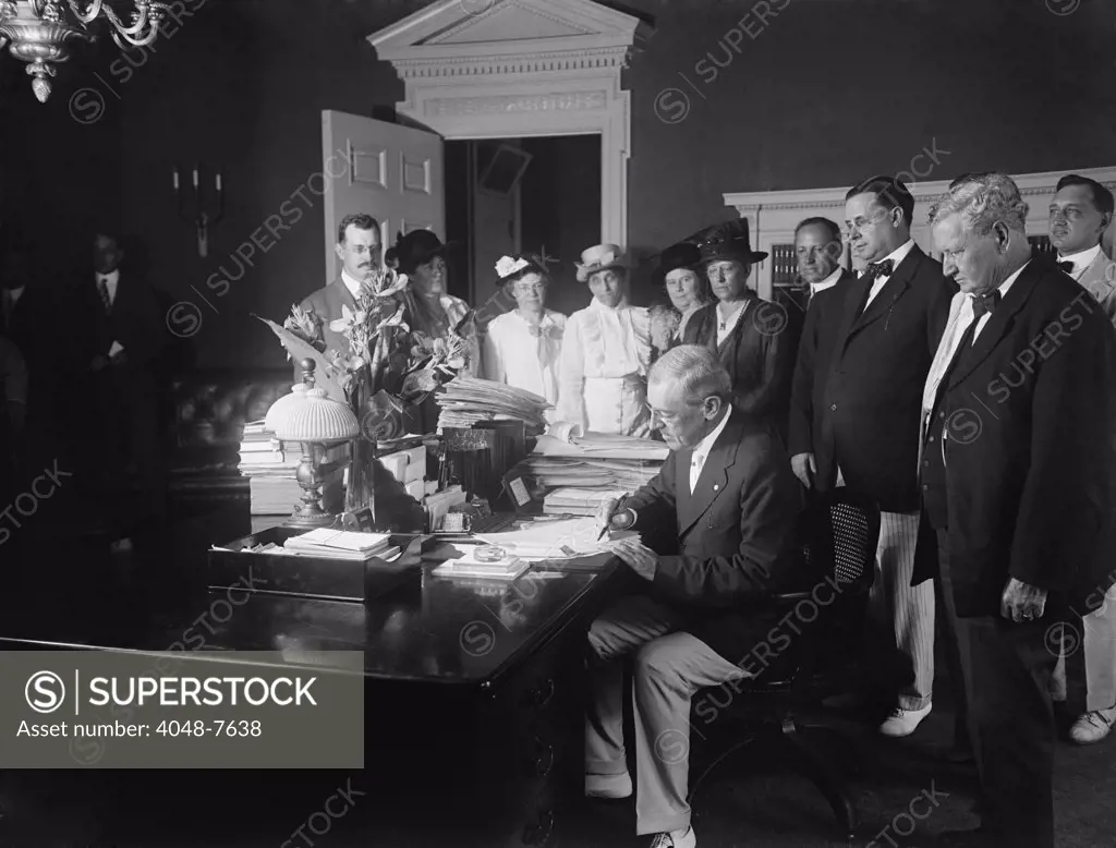 Woodrow Wilson signing the Child Labor Law of 1916, prohibiting interstate commerce of goods made using child labor. The law was stuck down by the Supreme Court for violating a child's right to contract his work.