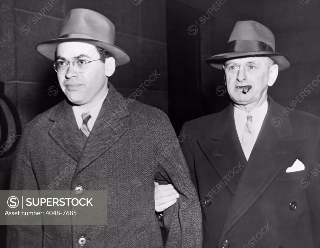 Morton Sobell left is escorted by a U.S. Marshall from City Prison to Federal Court March 6 1951. Sobell was tried with Julius and Ethel Rosenberg for conspiracy to commit espionage by passing atomic secrets to Soviet Russia.