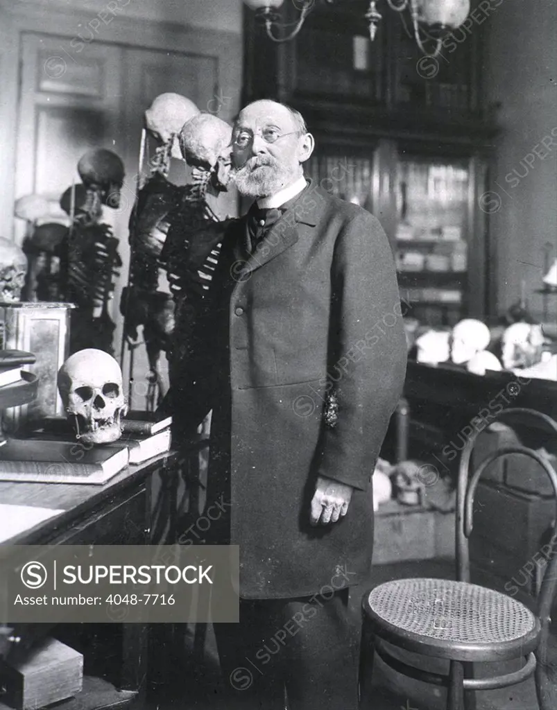 Rudolph Virchow 1821-1902 German pathologist physician and anthropologist standing with human skeletons. Ca. 1890.