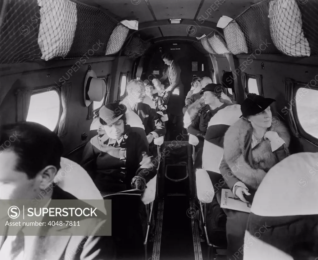 Stylishly dressed passengers seated in a commercial flight in the 1930s. LC-DIG-hec-14562