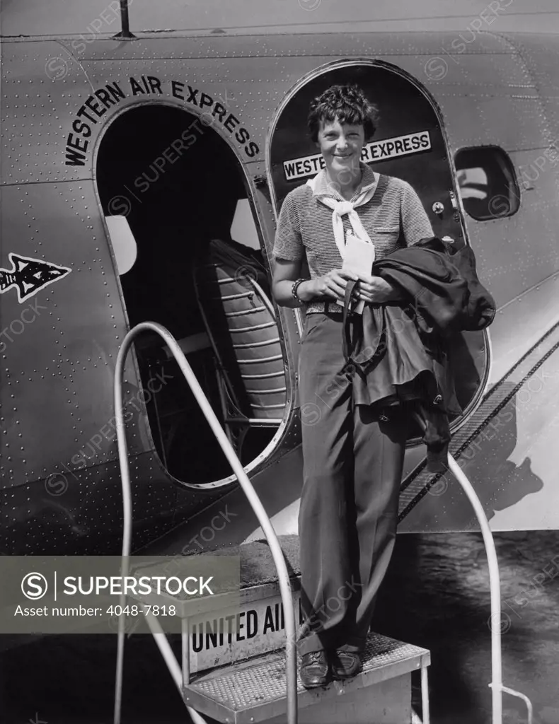 Amelia Earhart 1897-1937 standing in the door of a Western Airlines planes in California as she embarks to New York to make her first New York first public appearance at Carnegie Hall. 1930s.