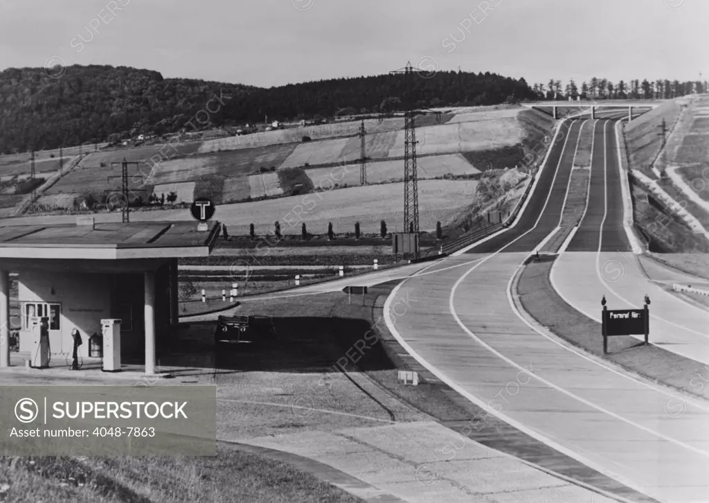Service Station of the German Autobahn a four lane divided highway with entrance and exit ramps. Ca. 1938