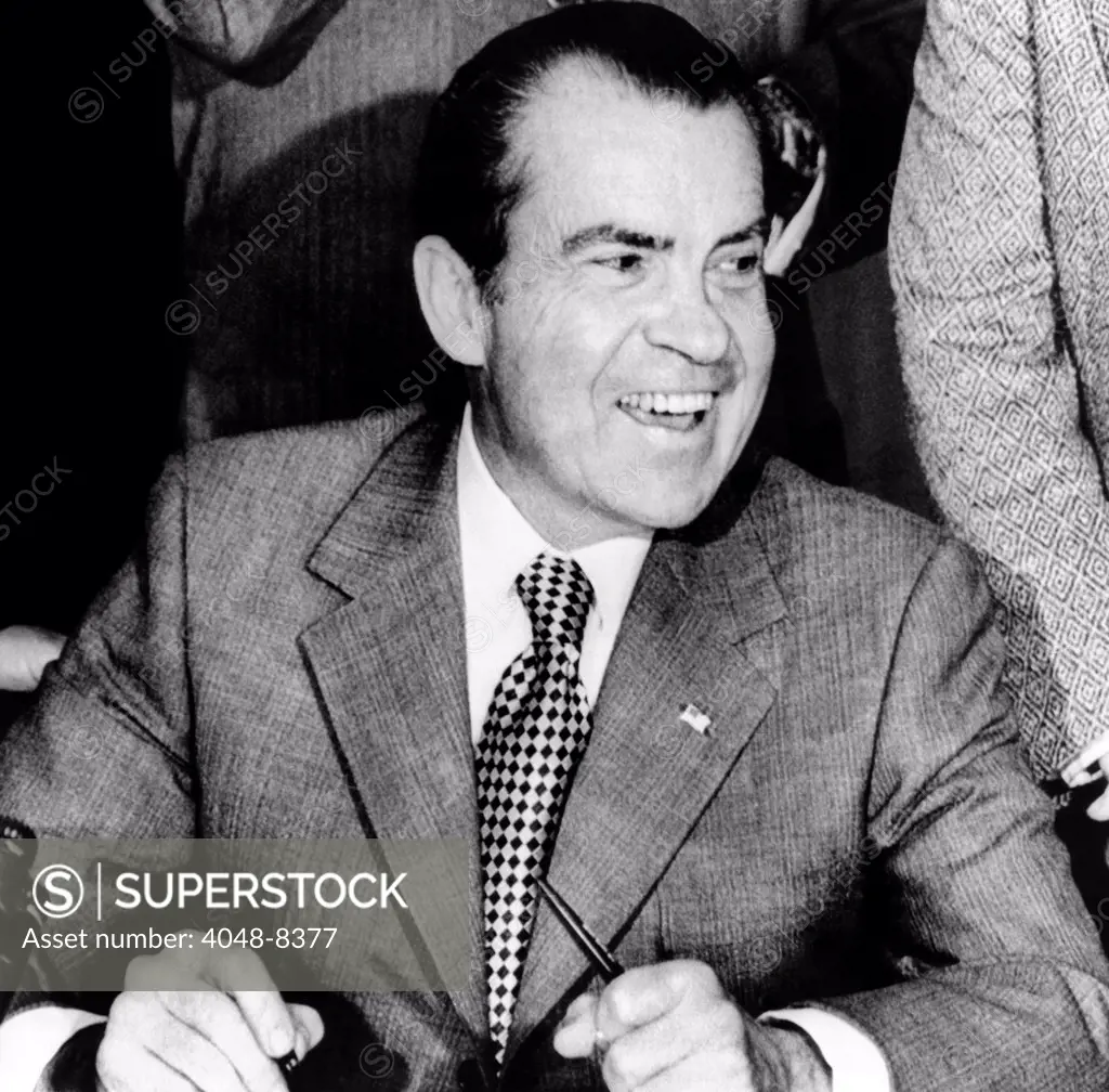 President Richard Nixon smiles during a White House signing ceremony. The bill will cut taxes $15.7 billion over the next 3 years and affect nearly every taxpayer from the poorest individual to the largest corporation. Dec. 10, 1971.