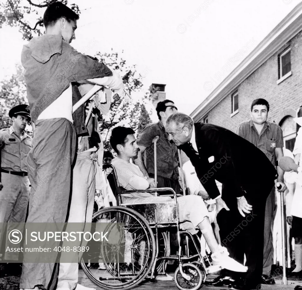President Lyndon Johnson greets wounded veterans at Walter Reed Hospital. L-R: SSgt. Robert C. Meier, SP/4 James G. Hartwick, E/5 Thomas Beil, and SP/4 James R. Tyree. June 11, 1968.