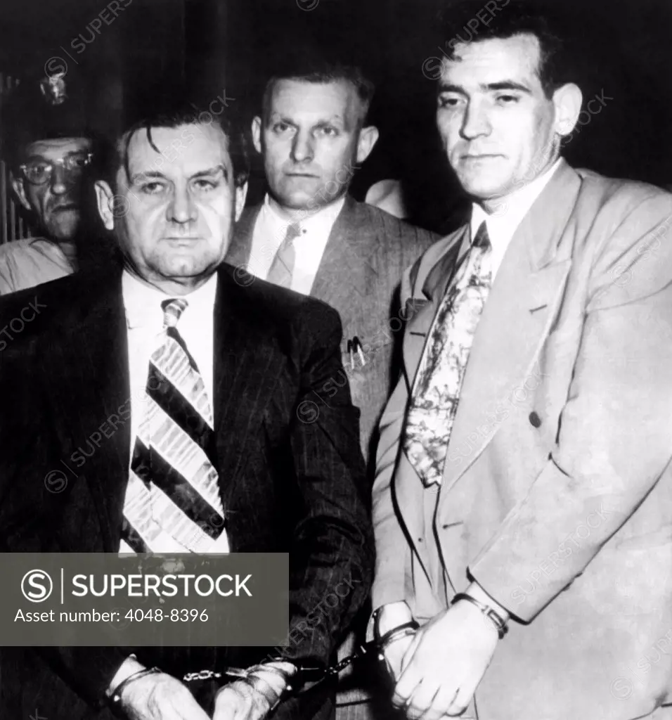 George 'Bugs' Moran and Virgil Summers, booked at Dayton, Ohio, for a $10,000 holdup of a local tavern. Behind are local police, in center, Detective C.M. Teeter. July 12, 1946.