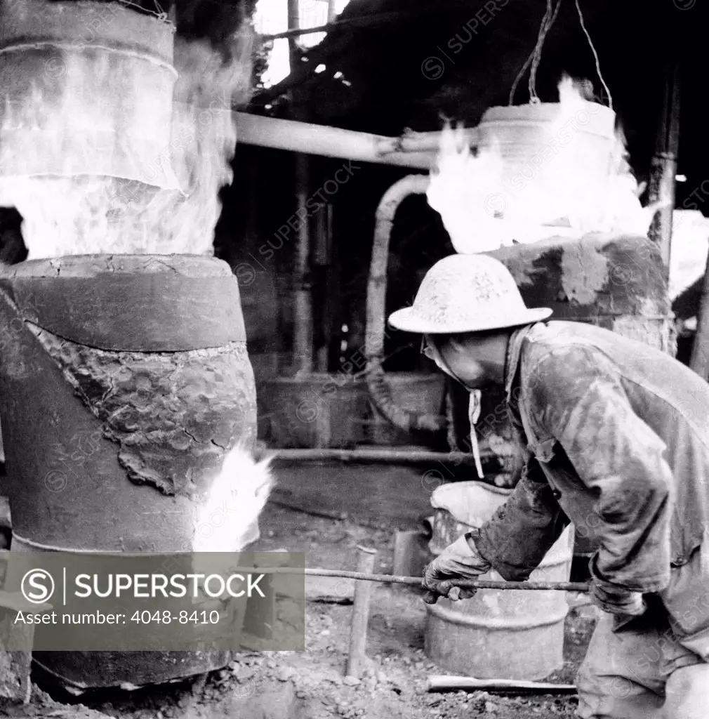 Backyard furnace in China during the disastrous 'Great Leap Forward.' The government encouraged peasants to make small quantities of steel in primitive backyard blast furnace. Over one million smelters were set up in the 'battle for steel'. The results were chaotic and uneconomic, and took farmers away from the fields. March 1962.