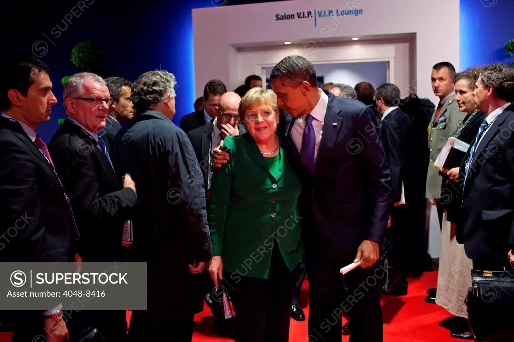 President Barack Obama walks with German Chancellor Angela Merkel after a meeting with Eurozone leaders at the G20 Summit in Cannes, France, Nov. 3, 2011.