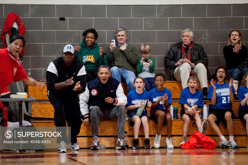 President Obama and aide Reggie Love (with hat) coaching daughter Sasha Obama's basketball team. Feb. 5, 2011