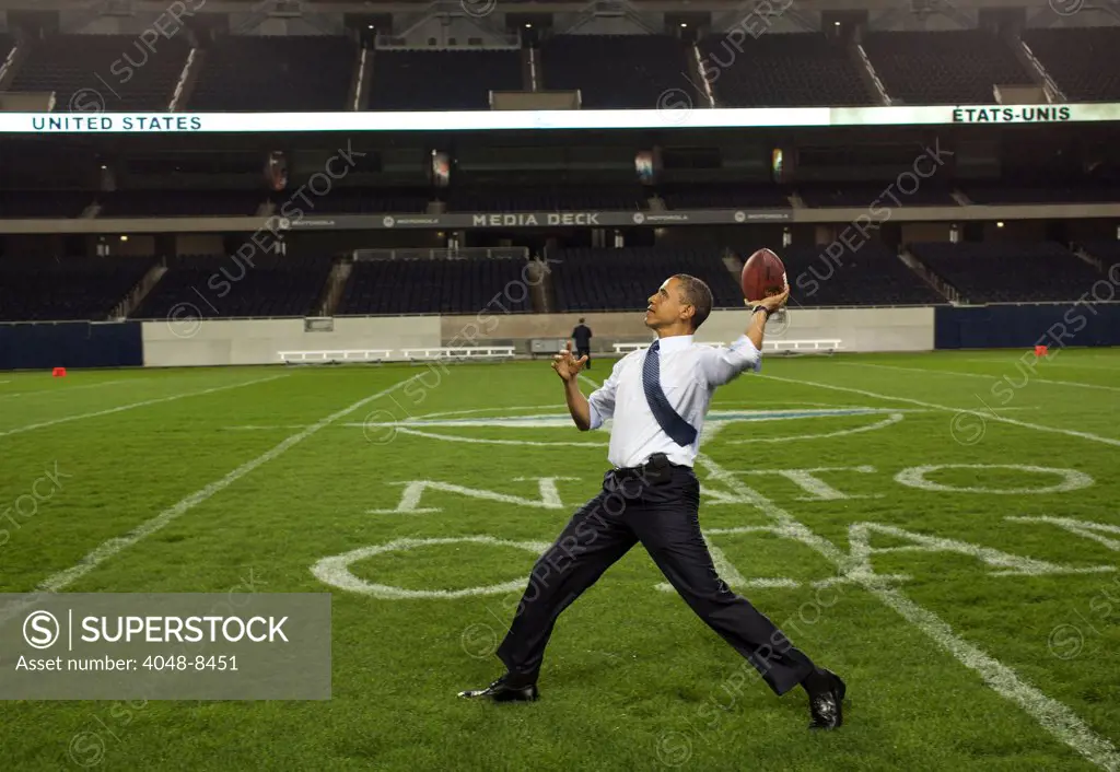 President Barack Obama throws a football on the field at Soldier Field following the NATO working dinner in Chicago, Illinois, May 20, 2012.