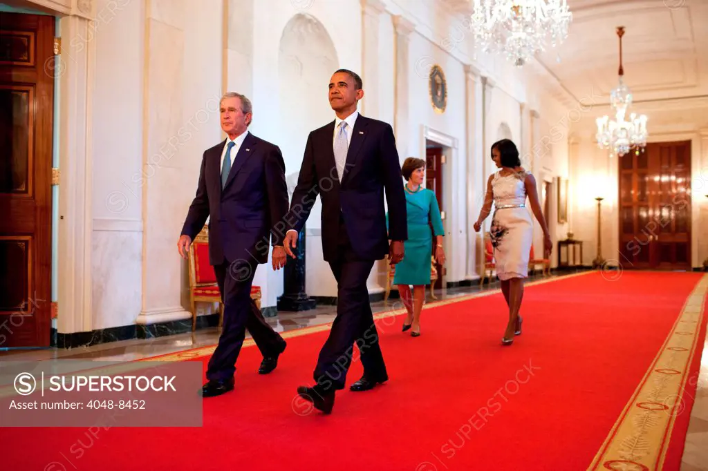 President Barack Obama and First Lady Michelle Obama walk with former President George W. Bush and former First Lady Laura Bush in the Cross Hall towards the East Room of the White House, May 31, 2012. The President and First Lady hosted a ceremony to unveil the Bushes' official portraits, which will be displayed in the White House.