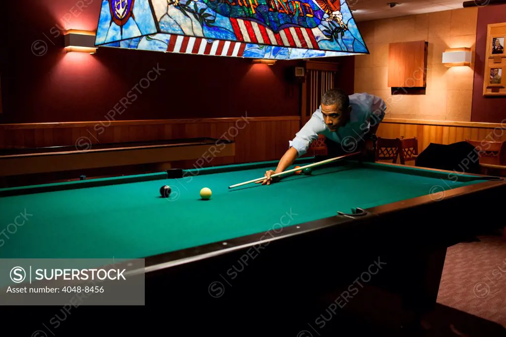 President Barack Obama plays a game of pool following the conclusion of the G8 Summit at Camp David, Md., May 19, 2012.