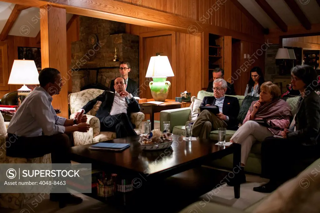President Barack Obama talks with President François Hollande of France, Prime Minister Mario Monti of Italy, and Chancellor Angela Merkel of Germany in the living room of Aspen Cabin during the G8 Summit at Camp David, Md., May 18, 2012.