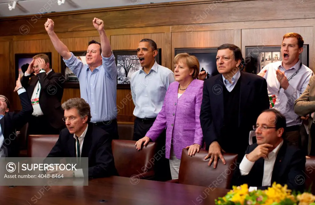 Prime Minister David Cameron of the United Kingdom, President Barack Obama, Chancellor Angela Merkel of Germany, José Manuel Barroso, President of the European Commission, and others watch the overtime shootout of the Chelsea vs. Bayern Munich Champions League final, in the Laurel Cabin conference room during the G8 Summit at Camp David, Md., May 19, 2012.