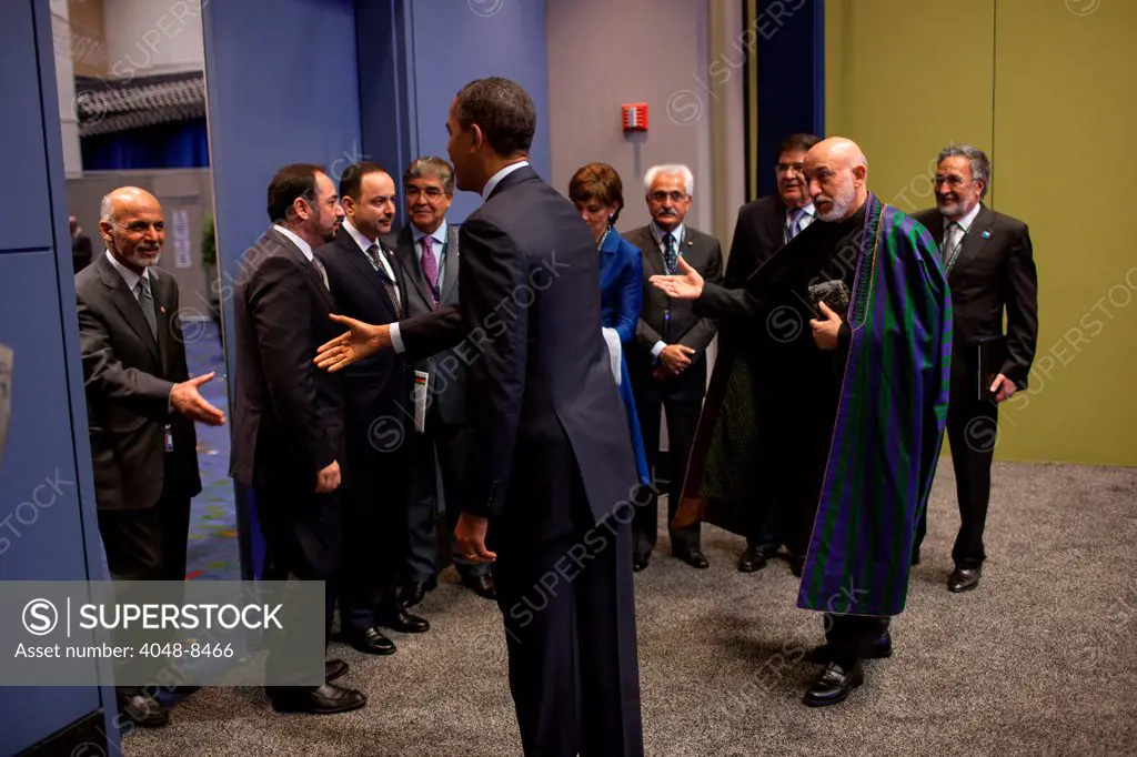 President Hamid Karzai of Afghanistan presents members of the Afghan delegation to President Barack Obama before their bilateral meeting during the NATO Summit in Chicago, Ill., May 20, 2012.